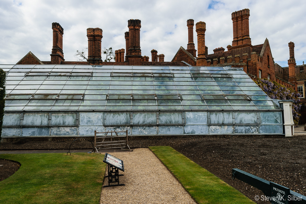 Hampton Court Palace Chimneys and the green house over the great grape vine.  Empty ground to right is over the vine root, for watering and fertilizing. (1/125 sec at f / 11,  ISO 100,  18 mm, 18.0-55.0 mm f/3.5-5.6 ) April 28, 2017